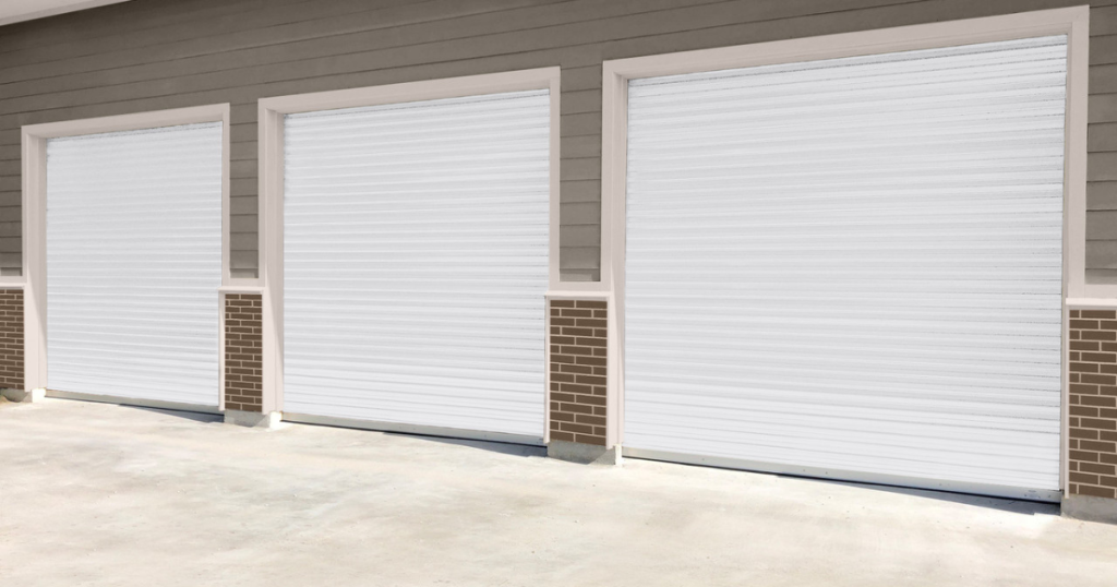 Three closed white roll-up garage doors.