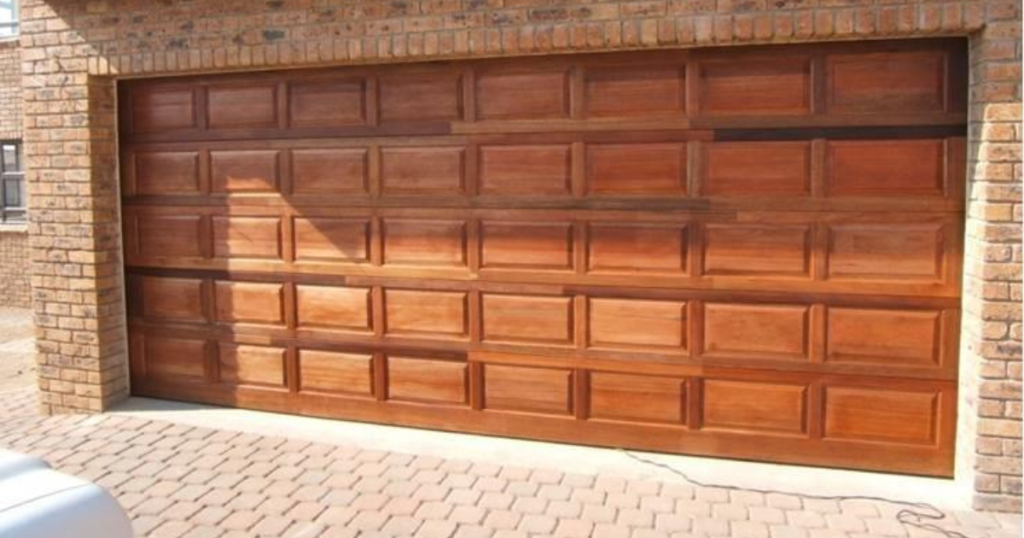 Paneled wooden garage door with shine.