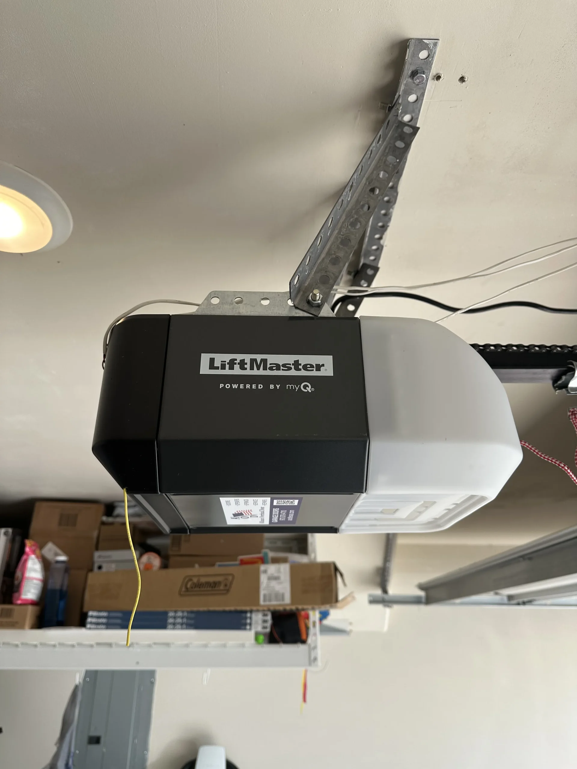 A close-up view of a LiftMaster automatic garage door motor unit mounted to a ceiling, perfect for diagrams explaining how a garage door opener works.