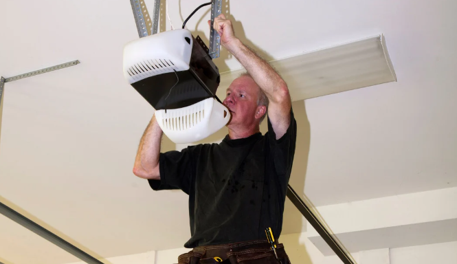 person maintaining a garage door opener