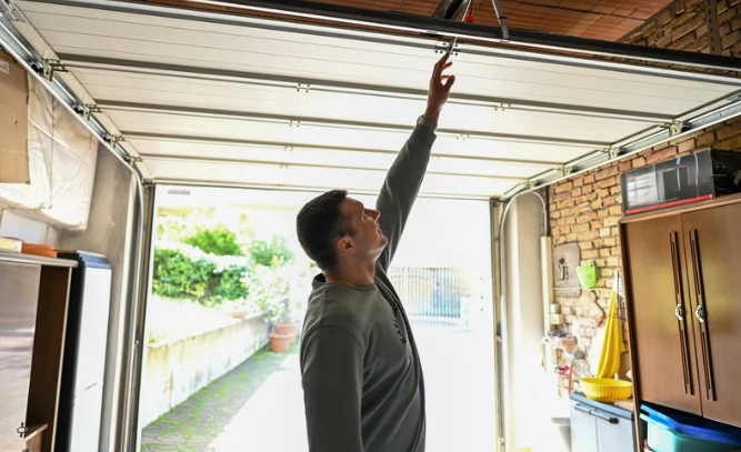 man reaching for garage door