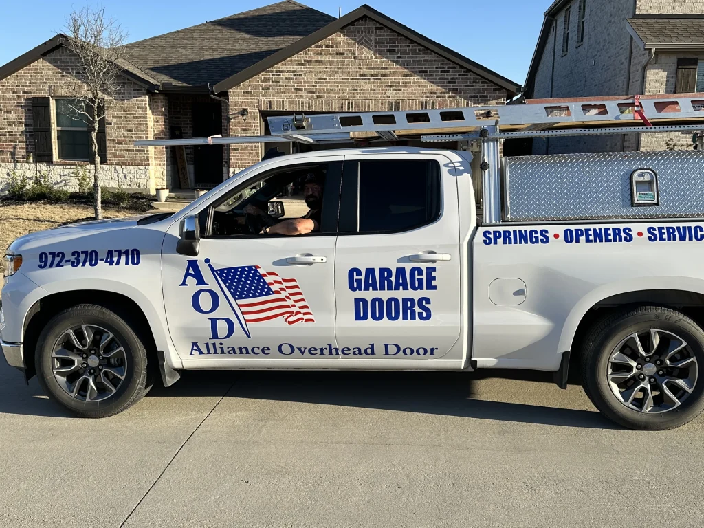 An Alliance Overhead Door company service truck parked in a residential driveway, perfect for locating professional garage door services near me in Celina, TX.